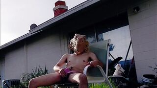 Thonged twink jerks off outside his ass drips on the grass