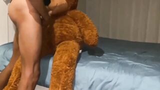 Gay twink takes big cock in his mouth while stuffed with his favorite teddy bear