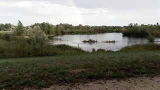 Gay boy pisses pee under rainbow in summer rain