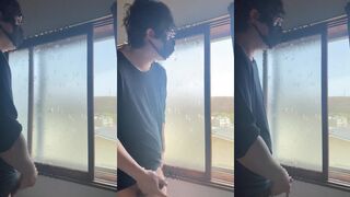 Sneaky twink jerks off by window drenched in thick white cum