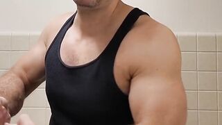 Flexing hairy muscle bear in tank top destroyed in gay body worship