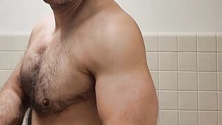 Flexing hairy muscle bear in tank top destroyed in gay body worship