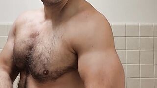 Flexing hairy muscle bear in tank top destroyed in gay body worship
