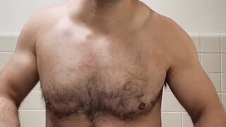 Flexing hairy muscle bear in tank top destroyed in gay body worship