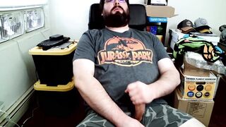 Bear in boxers strokes hard while jerking off to Jurassic Park on his computer chair