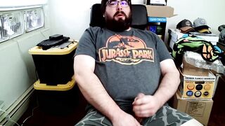 Bear in boxers strokes hard while jerking off to Jurassic Park on his computer chair
