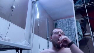 Chubby bear takes big black dildo deep throat