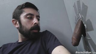Bearded white man slurping black cock at gloryhole