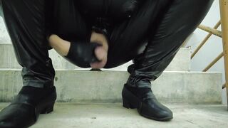 Latex bodysuit dude chokes on his own cum on staircase