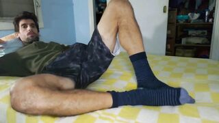 Athletic hunk with massive feet stroking his giant cock raw