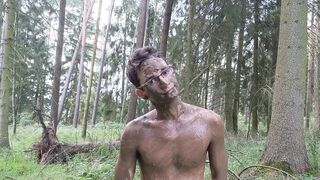 Twink strips naked in the forest smears mud all over his tight body