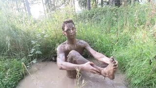 Twink strips naked in the forest smears mud all over his tight body